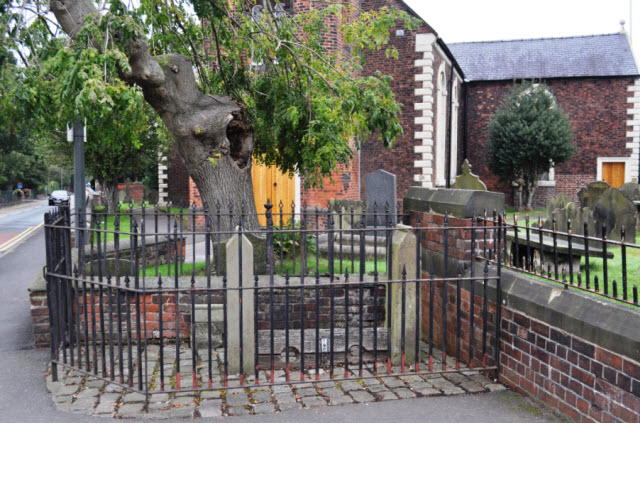Village Stocks against St Lukes churchyard wall